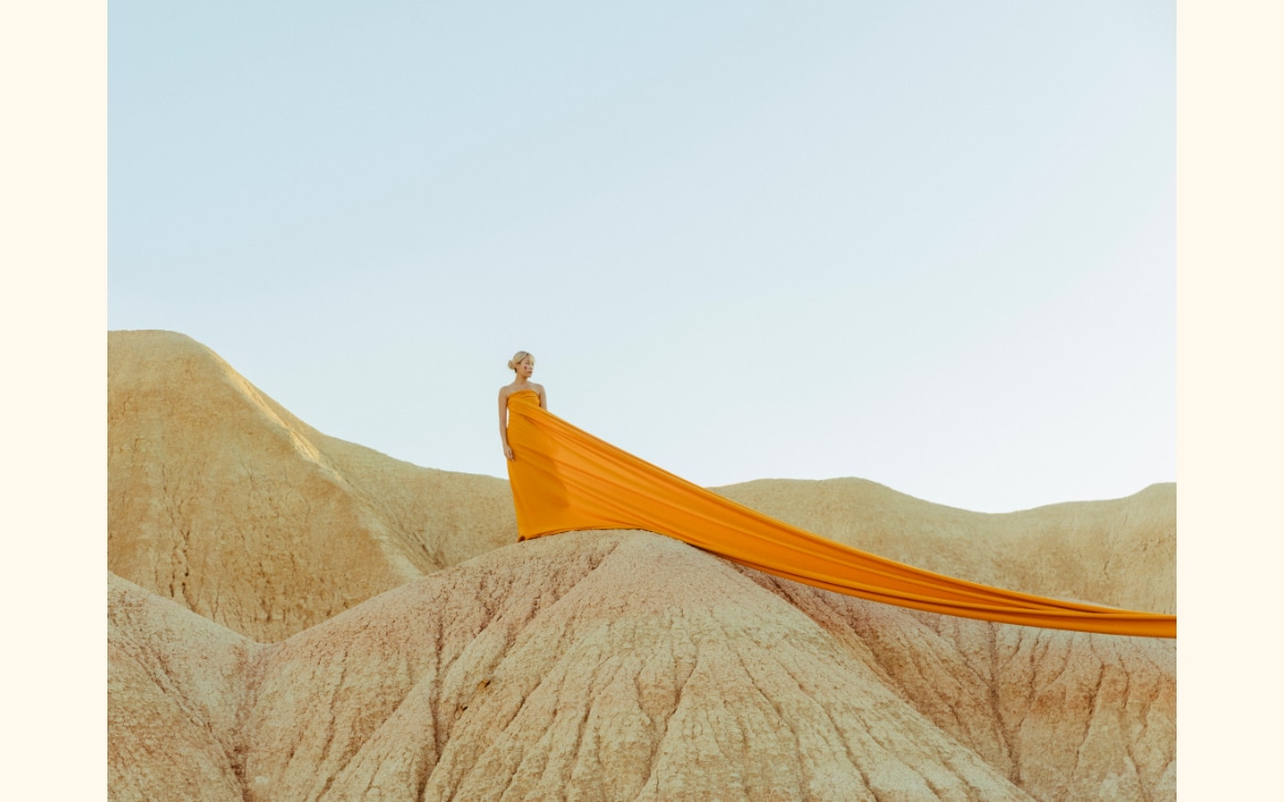 Nanna Heitmann photo of a woman wearing an orange dress in the desert Nanna Heitmann photo of a woman wearing an orange dress in the desert