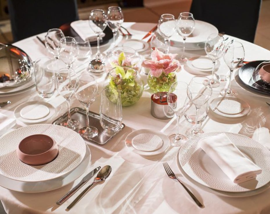 Beautifully decorated round table with glasses, plates and cutlery in the St Petersburg Cellier Beautifully decorated round table with glasses, plates and cutlery in the St Petersburg Cellier
