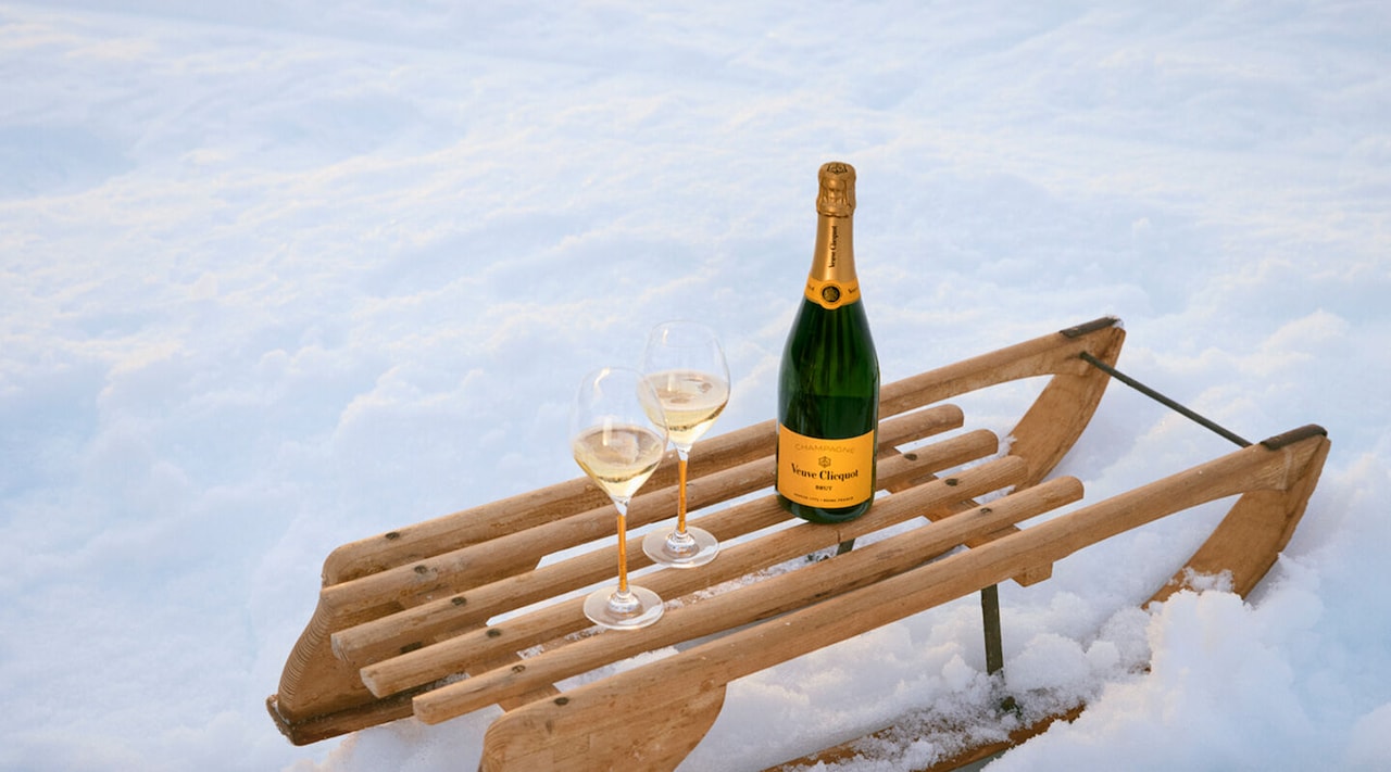 Veuve Clicquot Brut Yellow Label with two glasses in the snow