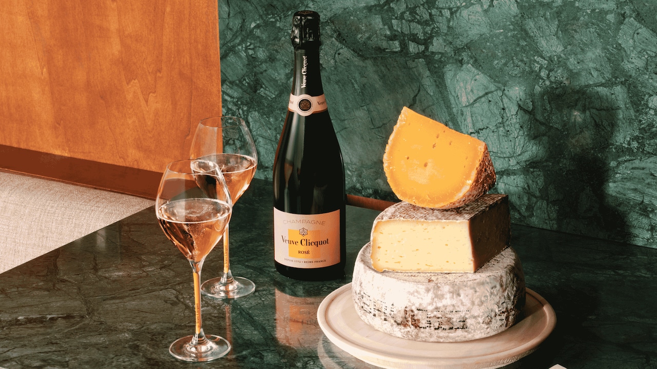 Veuve Clicquot Brut Ros&eacute; bottle and two glasses with cheese food pairing