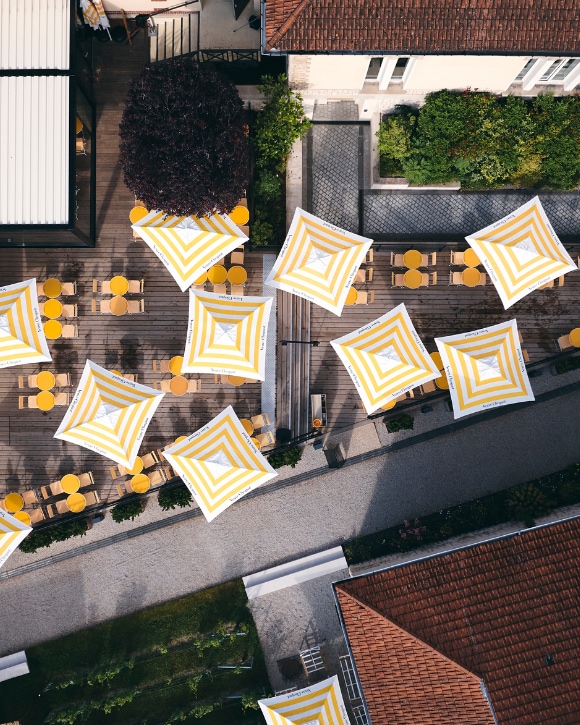 Café Clicquot's terrace view from above, with tables and umbrellas Café Clicquot's terrace view from above, with tables and umbrellas