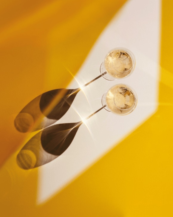 Two champagne flutes filled with Veuve Clicquot