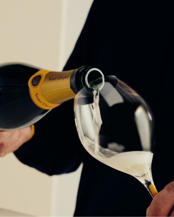 Veuve Clicquot A Clicquot Taste Brut Yellow Label and a glass