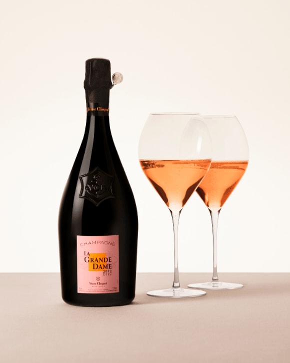 Veuve Clicquot La Grande Dame Ros&eacute; bottle with two filled champagne glasses, prestige cuv&eacute;e
