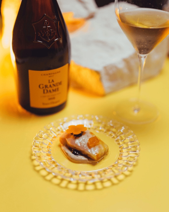 Food pairing with a bottle of La Grande Dame 2015 and a champagne glass