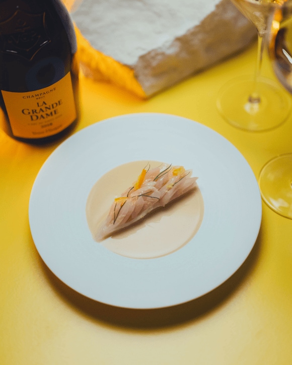 Food pairing with a bottle of La Grande Dame 2015 and a champagne glass