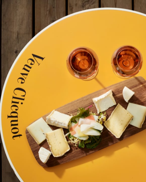 Cheese board with two glasses of champagne rosé Cheese board with two glasses of champagne rosé