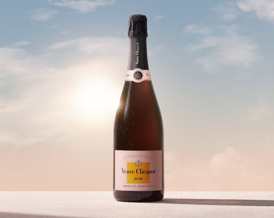 Clicquot Brut Rosé bottle in front of sunrise Clicquot Brut Rosé bottle in front of sunrise