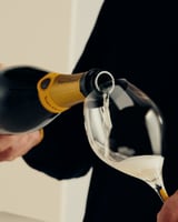 Veuve Clicquot A Clicquot Taste Brut Yellow Label and a glass
