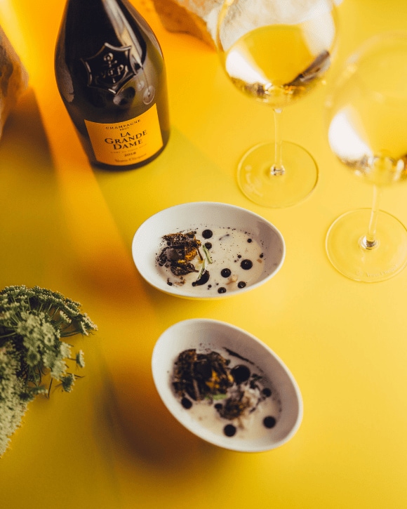 Food pairing with a bottle of La Grande Dame 2015 and a champagne glass