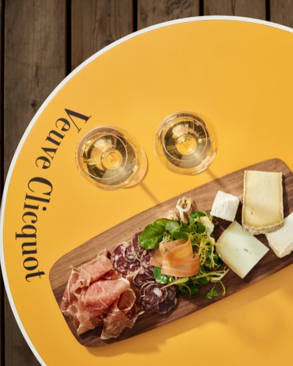 Charcuterie and cheese board with two glasses of champagne Charcuterie and cheese board with two glasses of champagne