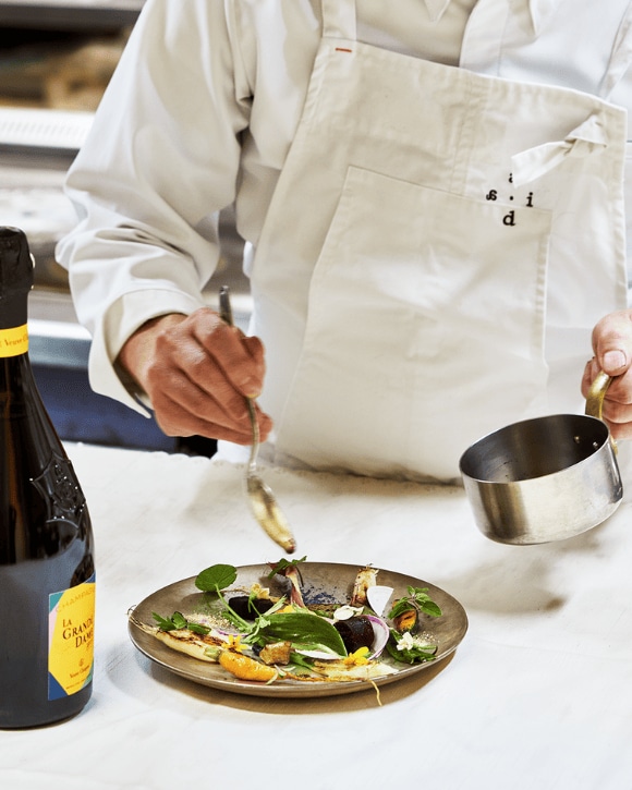 Kanji Kobayashi serving a gastronomic plate and a bottle of La Grande Dame 2015 Kanji Kobayashi serving a gastronomic plate and a bottle of La Grande Dame 2015