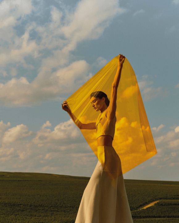 Woman in a field with a yellow cloth Woman in a field with a yellow cloth