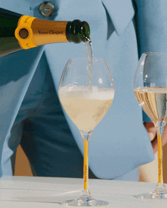 Serving a bottle of Veuve Clicquot on a table