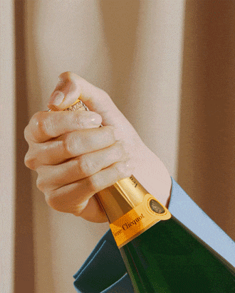 Popping cork of bottle of Veuve Clicquot