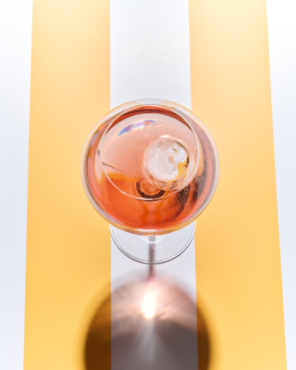 Glass of RICH Rosé champagne with an ice sphere